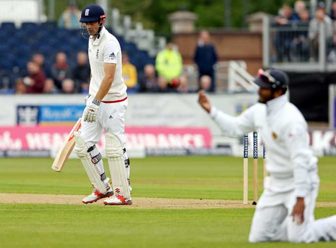 England captain Alastair Cook (L), reacts as he leaves the field after being caught out for 15 runs by Sri Lanka