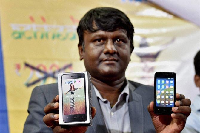 Madhava Reddy poses with the Namotel Achhe Din smartphone. Pic/PTI