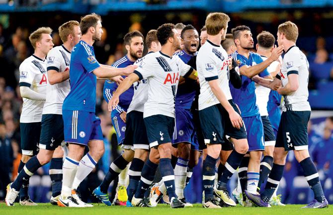 Players clash after a foul during the EPL match between Chelsea and Tottenham at Stamford Bridge in London Monday