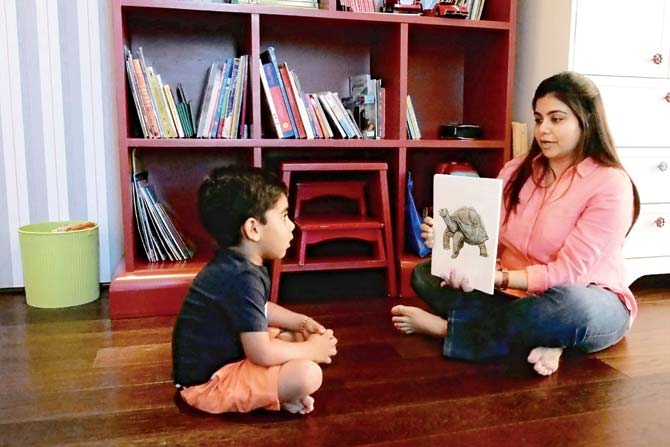 Tejal Bajla flashes a set of quantum cards before her son