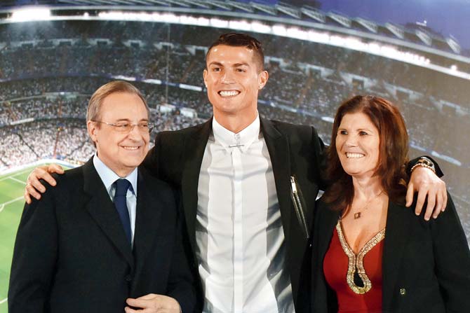 Ronaldo, Real Madrid president Florentino Perez (left) and Ron’s mother Maria Dolores dos Santos Aveiro pose for a picture during the official presentation of Ronaldo’s contract renewal at the Santiago Bernabeu stadium in Madrid yesterday. Pic/AFP