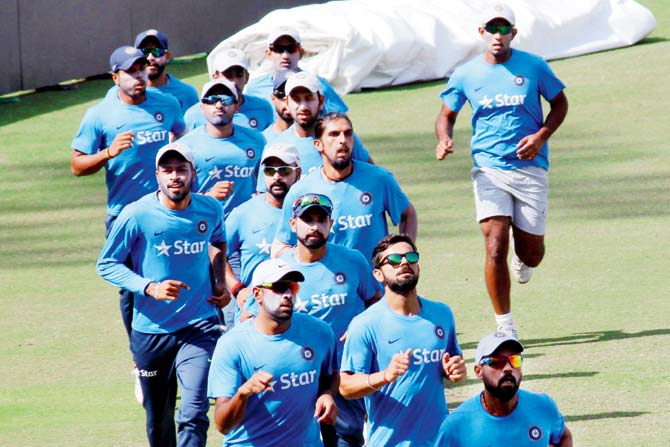 Murali Vijay (right) leads Team India in a run during a training session at Saurashtra CA Stadium in Rajkot yesterday. Pic/Bipin Tankaria