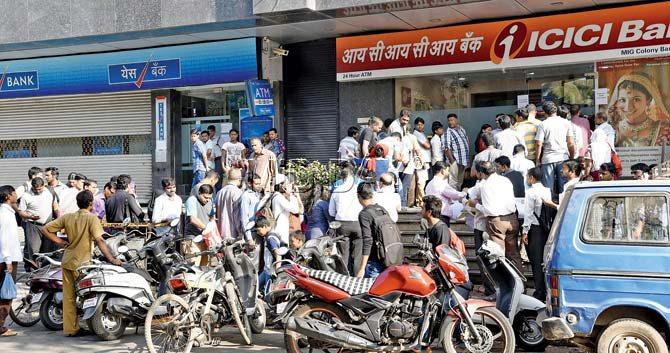 A crowd outside ICICI bank in Bandra (E). Pic/Pradeep Dhivar
