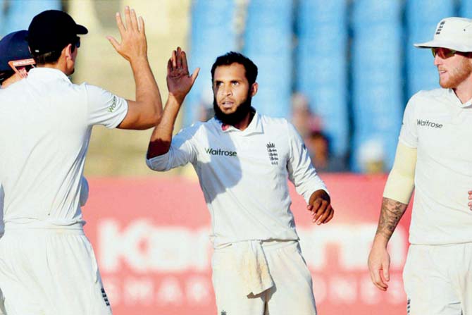 England bowler Adil Rashid (right) celebrates the wicket of Murali Vijay on the third day of the first Test in Rajkot yesterday. Pic/PTI 