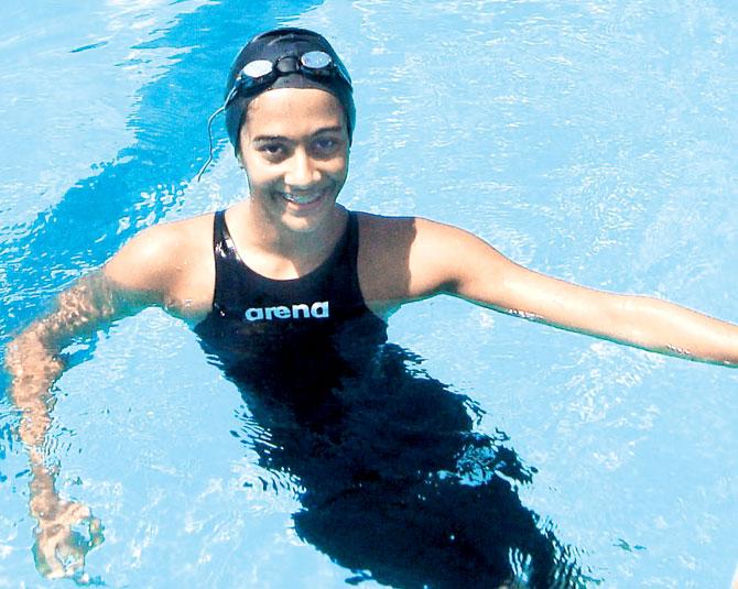 Kenisha Gupta relaxes in the pool after her medal-winning feat