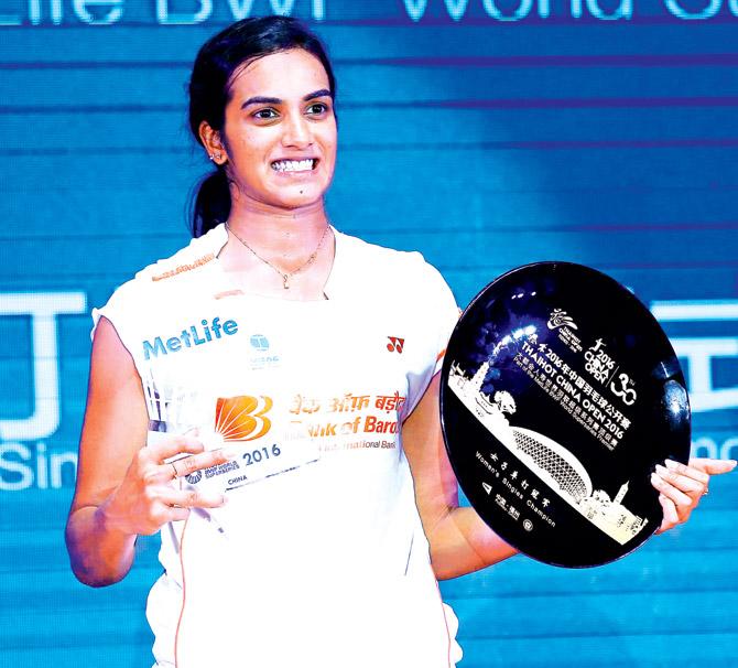 PV Sindhu with the trophy. Pics/AFP