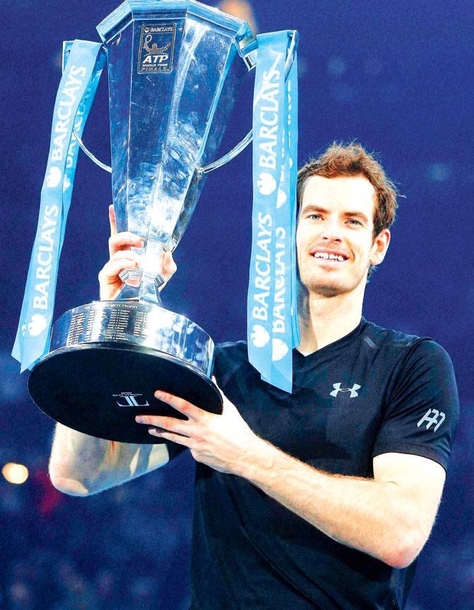 Andy Murray holds the trophy after winning the ATP World Tour Finals match against Djokovic in London on Sunday. Pic/AP,PTI