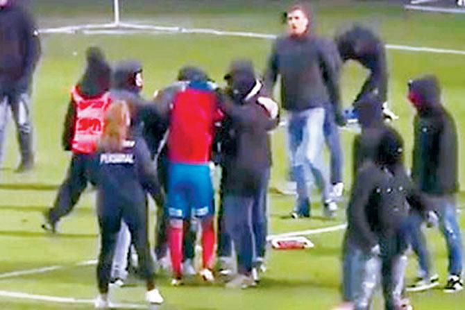 A video grab shows a group of fans attacking Larsson’s son Jordan (red jersey) after a football match in Sweden 