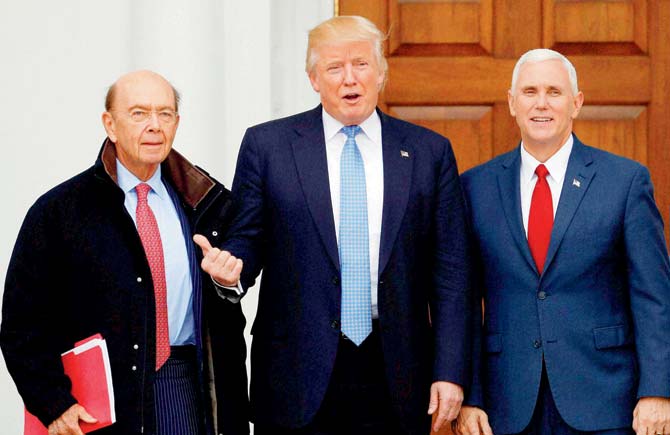 President-elect Donald Trump and Vice President-elect Mike Pence pose with investor Wilbur Ross (left) at the Trump National Golf Club Bedminster clubhouse. Pic/AP/PTI