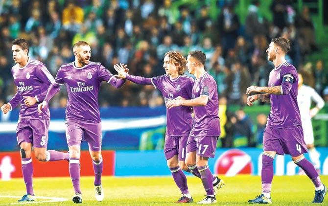 Real Madrid forward Karim Benzema (second from left) celebrates a goal with teammates during the Champions League match against Sporting CP at the Jose Alvalade Stadium in Lisbon last night. Pic/AFP