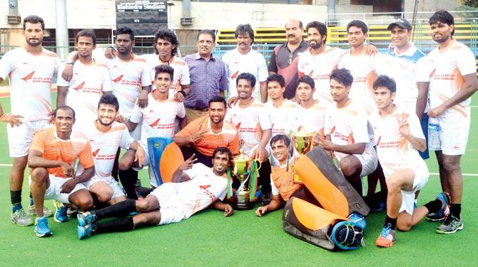 Members of the Air India team pose after winning the Guru Tej Bahadur Gold Cup hockey tournament in Mumbai last year