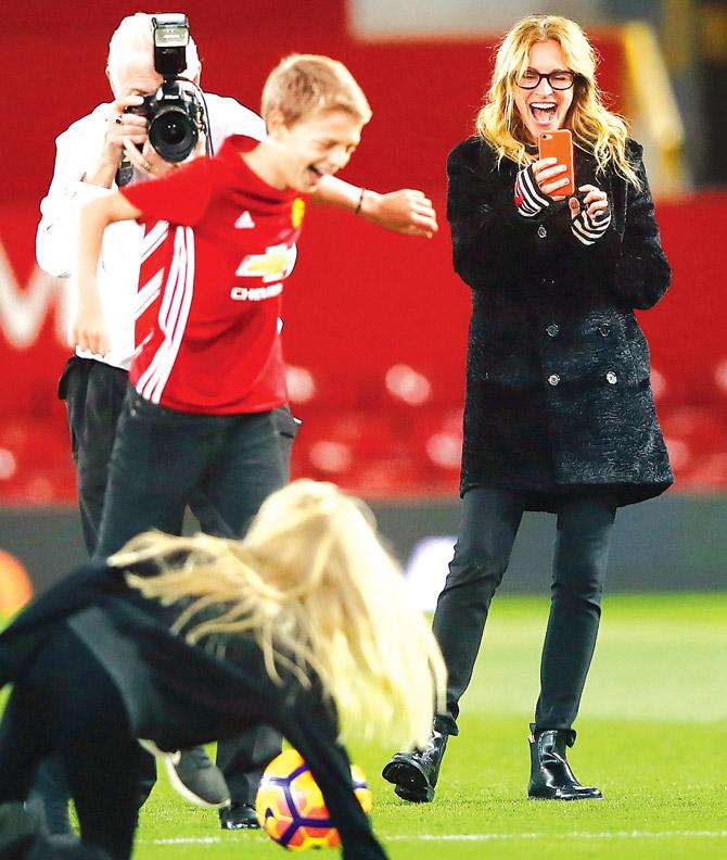 Actress Julia Roberts clicks photos of her children on the pitch after the English Premier Leagueâu00c2u0080u00c2u0088match between Manchester United and West Ham United at Old Trafford on Sunday. Pic/Getty Images