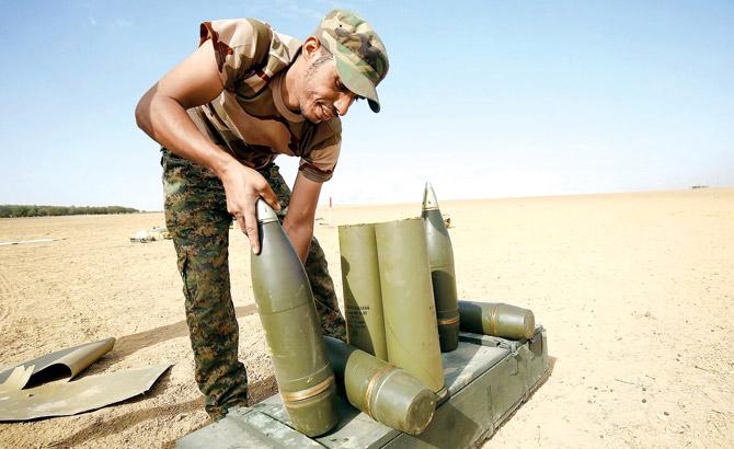 A shiite fighter prepare missiles to hit Islamic State group