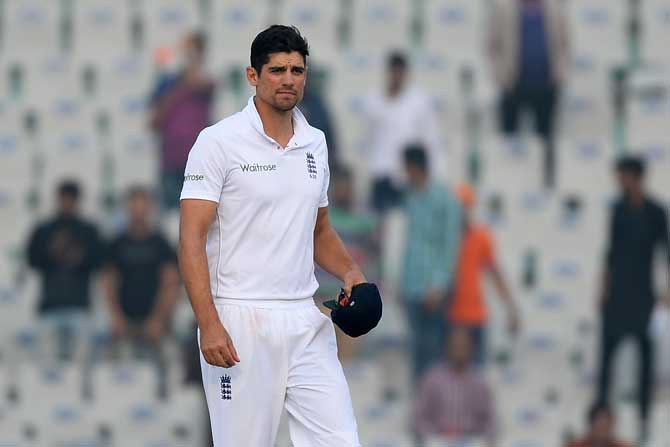 England captain Alaister Cook walks off the field after losing the third Test match against India at Mohali. Pic/ AFP