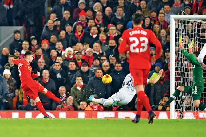 Liverpool’s Ben Woodburn (left) scores during the League Cup quarter-final against Leeds at Anfield in Liverpool last night. Pic/ AFP