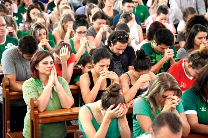 Fans attend a mass offered in memory of Chapecoense’s deceased players. PIC/AFP