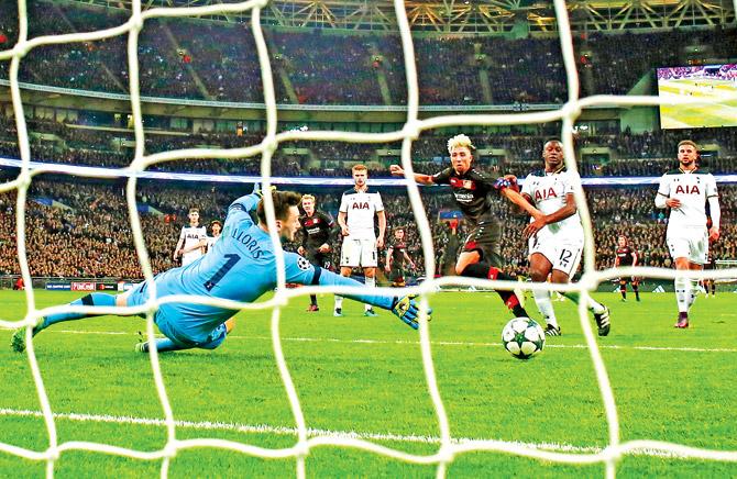 Tottenham Hotspur goalkeeper Hugo Lloris (left) fails to stop a shot from Bayer Leverkusen