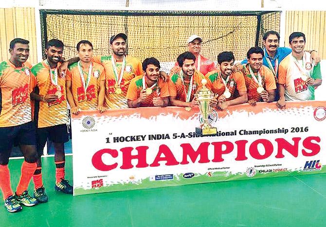 Yuvraj Walmiki holds the trophy after Maharashtra won the first Hockey India five-a-side Senior Nationals at the Shiv Chhatrapati Sports Complex in Balewadi, Pune recently