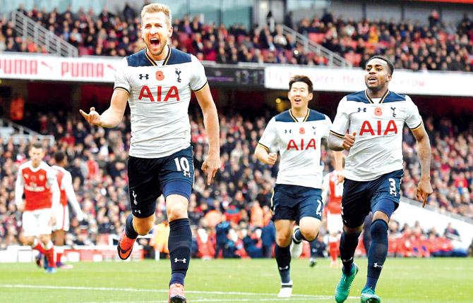 Spurs striker Harry Kane (left) is ecstatic after scoring a goal during the English Premier League match vs Arsenal yesterday. Pic/AFP