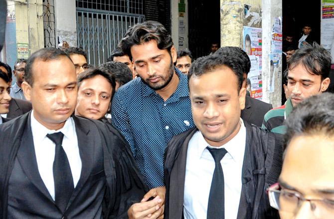 Bangladeshi cricketer Shahadat Hossain (centre) outside a court in Dhaka yesterday after being acquitted in a maid torture case. Pic/AFP