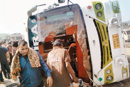 Luxury bus topples over at Thane, driver absconding