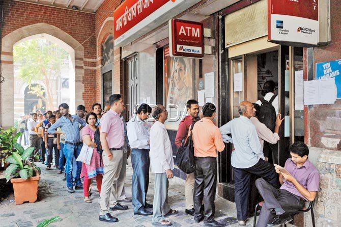 People queue up outside an ATM at Fort on Monday. Pics/Datta Kumbhar