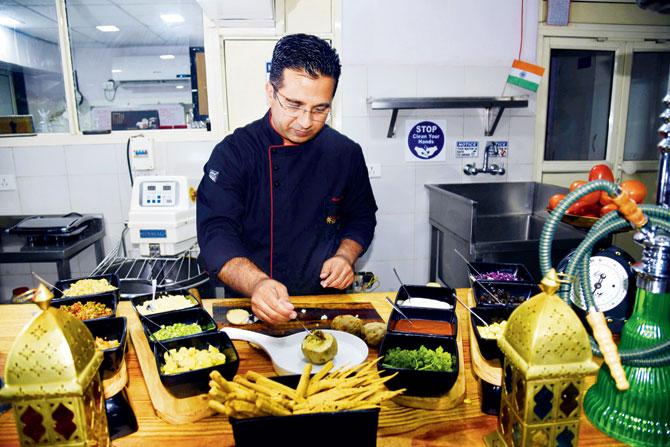 Khan in his kitchen making the kumphir. Pic/Pradeep Dhivar