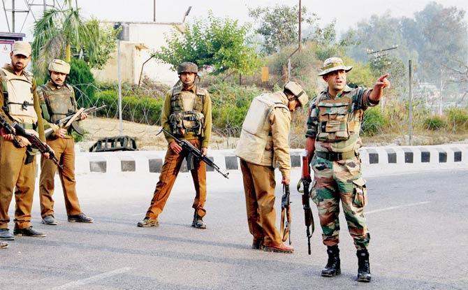 Security personnel during the gun battle with suspected militants at the Army camp in Nagrota. Pics/PTI