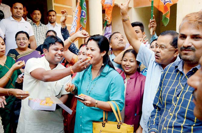 BJP workers celebrate the win in Guwahati. Pic/PTI