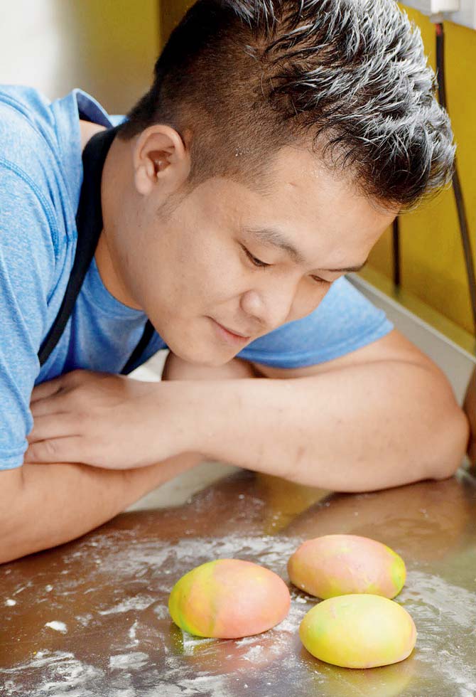 Co-founder Biki Gurung uses rainbow-coloured buns to make their banh-mi