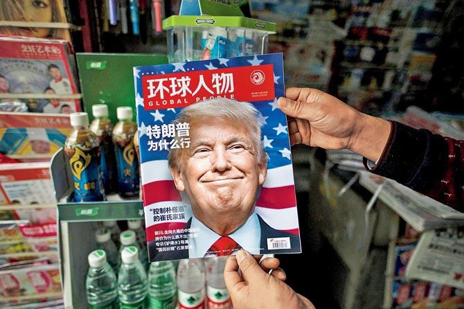 A copy of the Chinese magazine Global People with a cover story that translates to “Why did Trump win” is seen with a front cover portrait of Trump. Pic/AFP