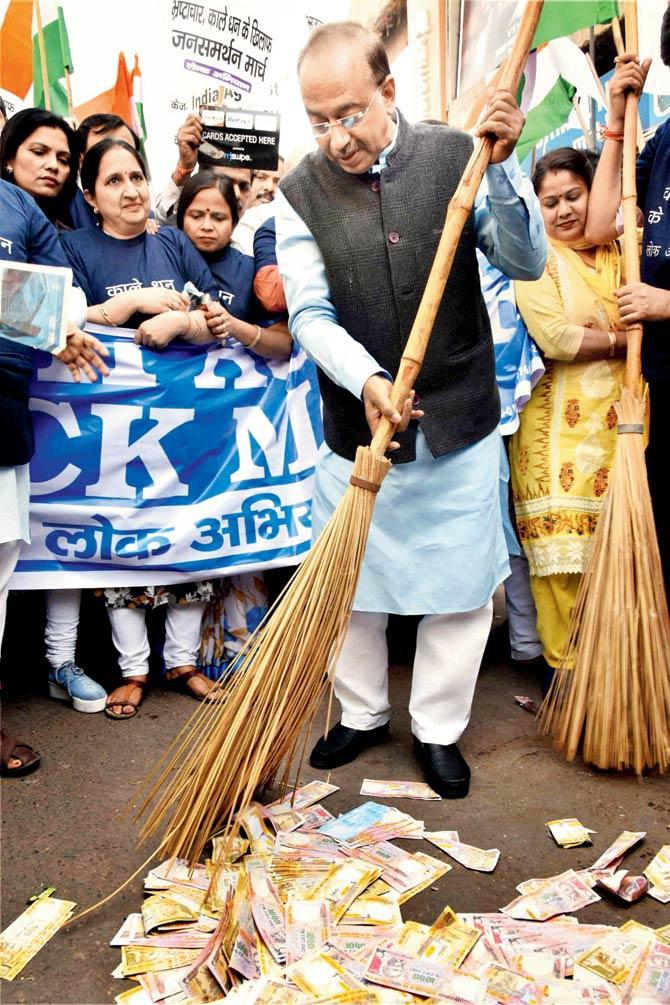Sports Minister Vijay Goel wields the broom against ‘black money’ during a march by Lok Abhiyan volunteers in support of demonetisation, in the capital yesterday. Pic/PTI
