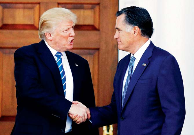 President-elect Donald Trump and Mitt Romney shake hands at the Trump National Golf Club Bedminster, New Jersey. Pic/AP/PTI