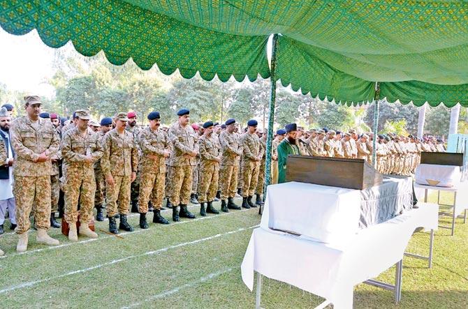 Pakistani army chief Raheel Sharif (4L) and military officials offer funeral prayers for the soldiers who were killed. Pic/AFP