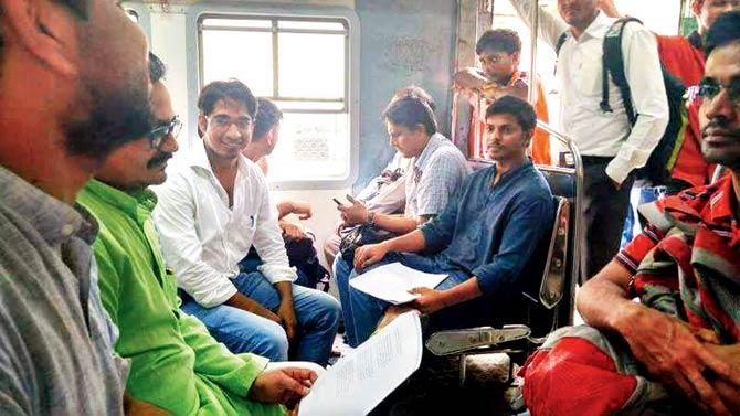 The gang during one of their poetry reading sessions in a local train; Parmeshwar, Mandar, Omkar, Praveen, Dhamma, Charan, Asif, Harish and Siddharth perform during a meeting. Pics/Poonam Bathija