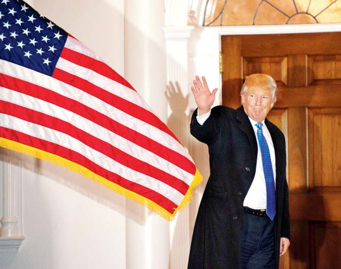 President-elect Donald Trump waves to the media at the Trump National Golf Club in Bedminster, New Jersey on Sunday. Pic/AFP