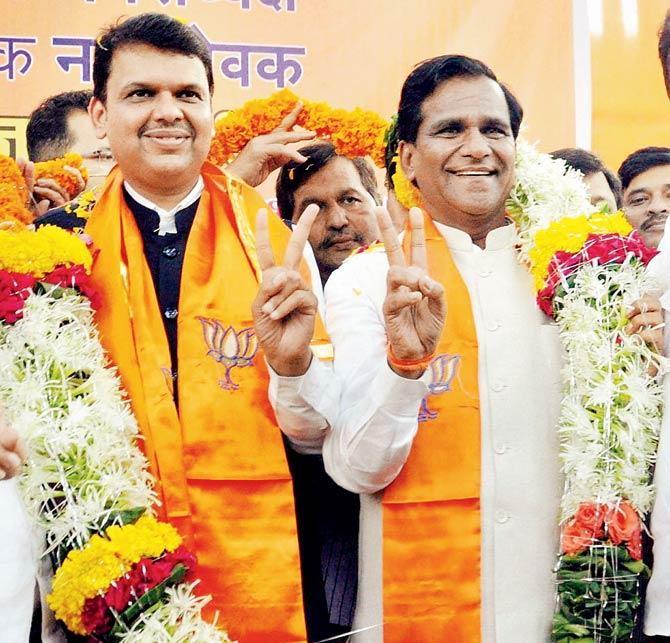 CM Devendra Fadnavis and BJP state president Raosaheb Danve are garlanded at the party headquarters in south Mumbai during the celebration of the party’s victory in the first phase of civic polls. Pic/PTI 
