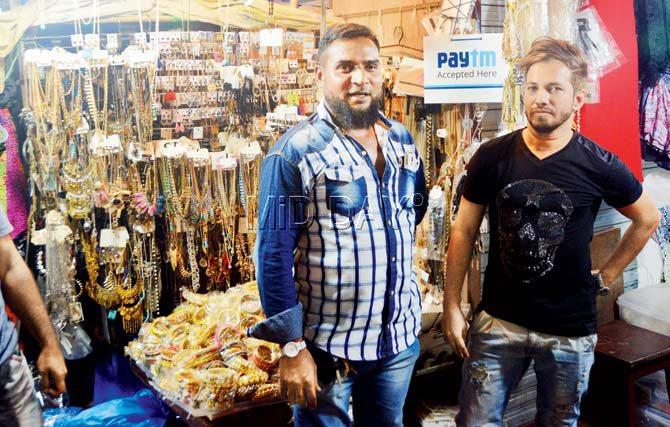 Salim Noor (right), a jewellery seller at Linking Road, Bandra, has begun accepting payment online. Pic/Satej Shinde