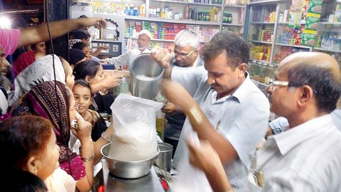 People crowd at a store after rumours of salt and sugar rate hike