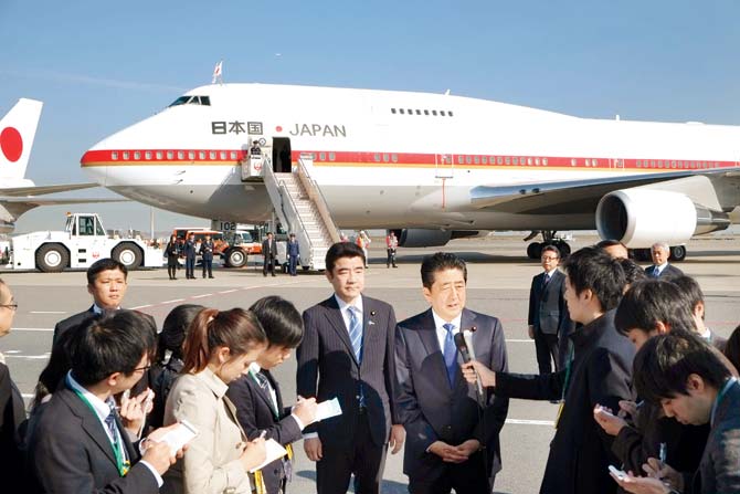 Japan’s Prime Minister Shinzo Abe (C) speaks to reporters prior to boarding a government plane at Tokyo’s Haneda Airport, headed to New York. Pic/AFP