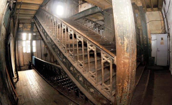 The once-grand staircase is now in ruins yet, look closely to gaze at its fine cast iron designs