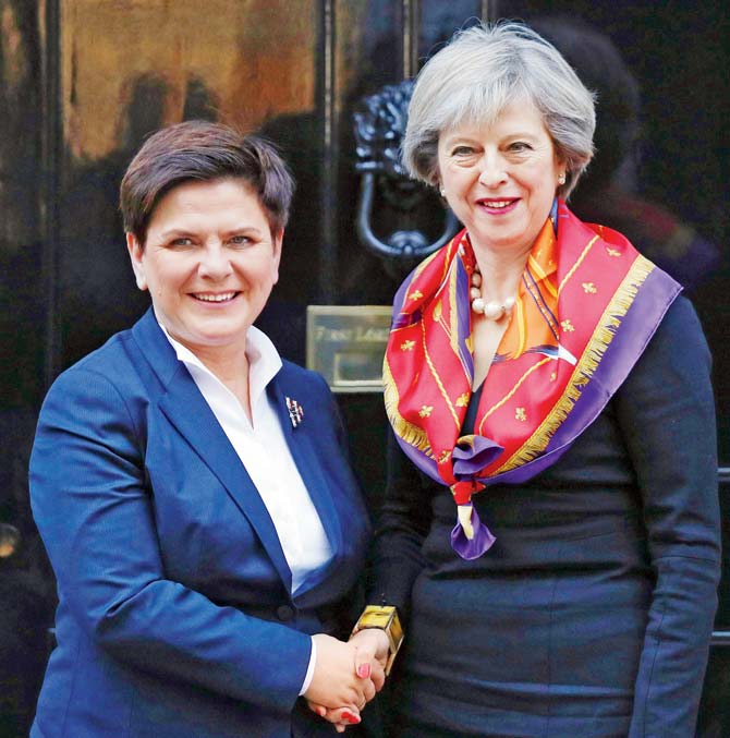 British PM Theresa May (R) greets Polish PM Beata Szydlo, who yesterday called for a Brexit “compromise”. Pic/AFP
