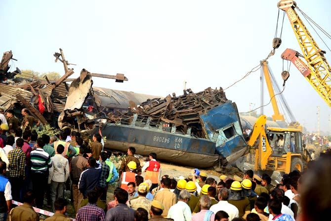 Indian rescue workers search for survivors in the wreckage of a train that derailed near Pukhrayan in Kanpur district. Pic/PTI
