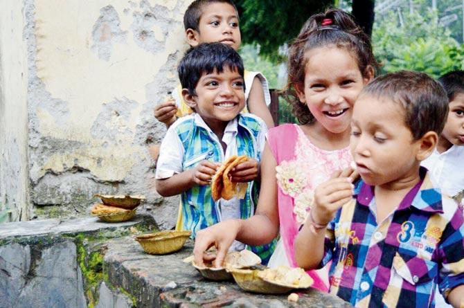 Underprivileged kids enjoy a meal courtesy of the Robin Hood Army. File pics