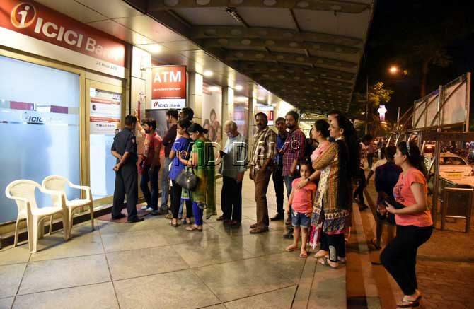 Long queue outside ATM centre at Vile Parle in Mumbai on Tuesday, November 08, 2016 after Prime Minister Narendra Modi, in an unexpected address to the nation on Tuesday, said that the country was doing away with Rs 500 and Rs 1,000 notes in an effort to weed out corruption, black money and in turn poverty and terrorism. Modi said that the government believes the time has come to "take a strong decision" on tackling these problems, suggesting that counterfeit notes from across the border were being used to fund terrorism in India. PIC/RANE ASHISH