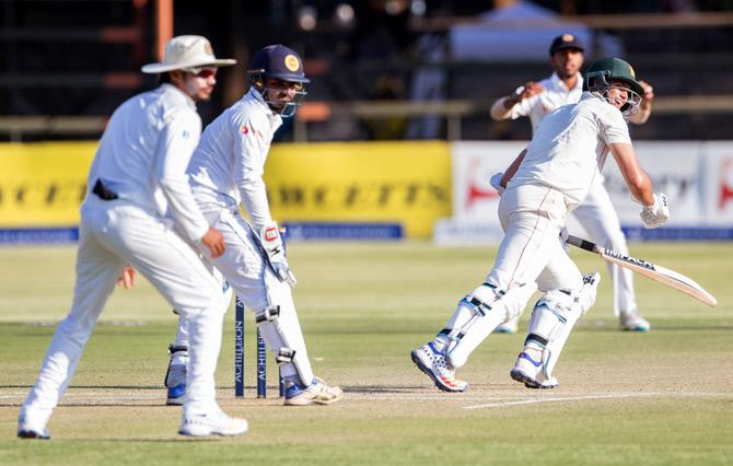 Zimbabwe captain Graeme Cremer (R) runs during the third day of the first Test match
