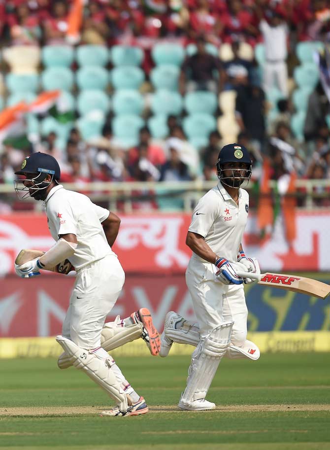 Virat Kohli and Cheteshwar Pujara run between the wickets