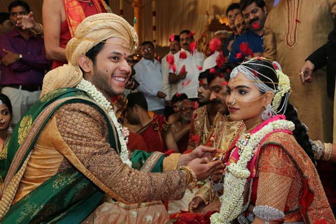 Daughter of Gali Janardhan Reddy, Bramhani (R) sits with her groom, Rajeev Reddy during their wedding at the Bangalore Palace Grounds in Bangalore.  AFP PHOTO / JANARDHANA REDDY FAMILY