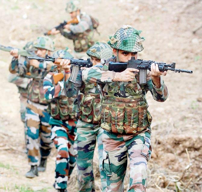 Indian army soldiers patrol near the Line of Control in Pallanwal sector about 70 km from Jammu. Pic/PTI