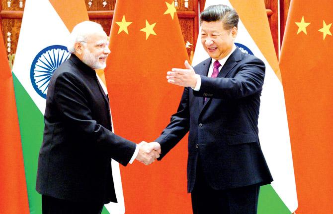 Chinese President Xi Jinping, seen here with Prime Minister Narendra Modi, will visit India this week